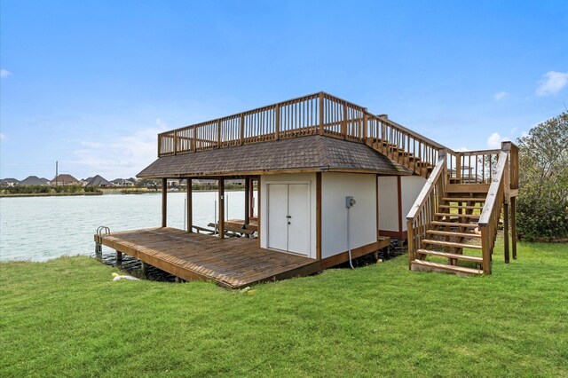 view of dock featuring stairs, a water view, and a yard