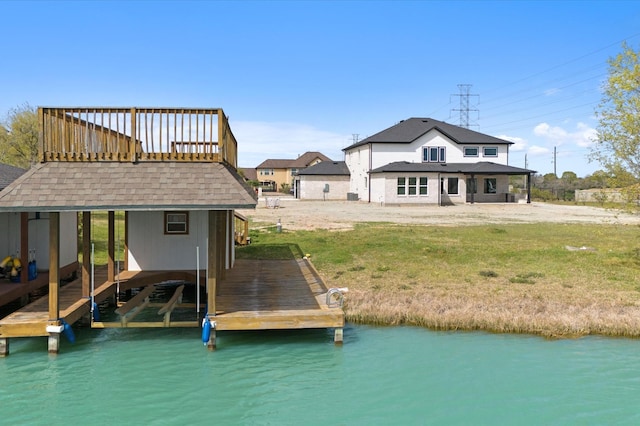 dock area with boat lift and a yard