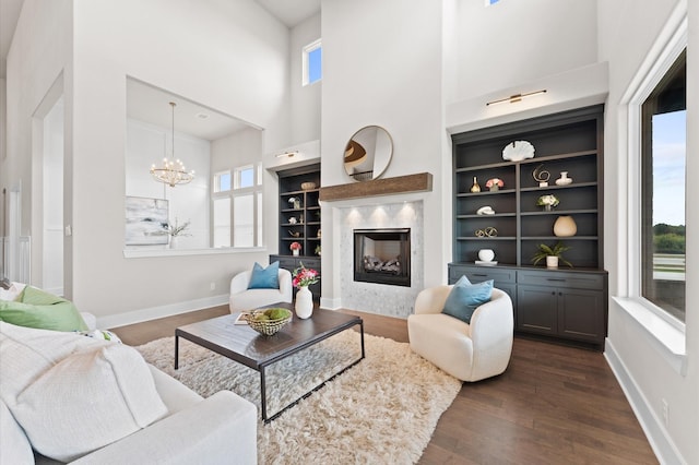 27003 Skiers Crossing Dr, Katy, TX 77493 - living room featuring healthy amount of natural light, a high ceiling, dark wood-style flooring, and a premium fireplace