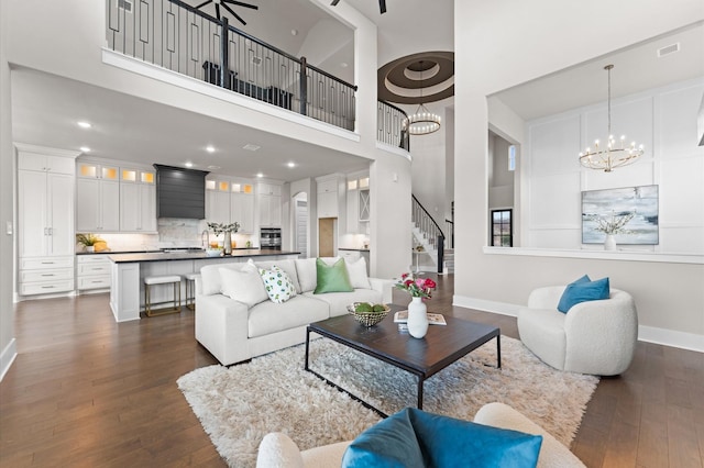 27003 Skiers Crossing Dr, Katy, TX 77493 - living area with a towering ceiling, dark wood-style floors, a chandelier, stairway, and recessed lighting