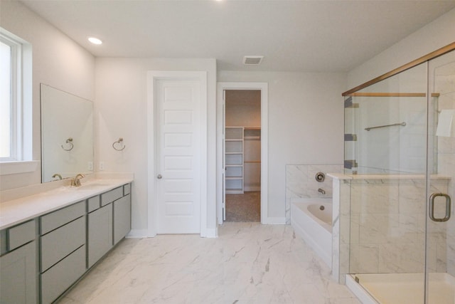 bathroom featuring visible vents, vanity, marble finish floor, a stall shower, and a garden tub
