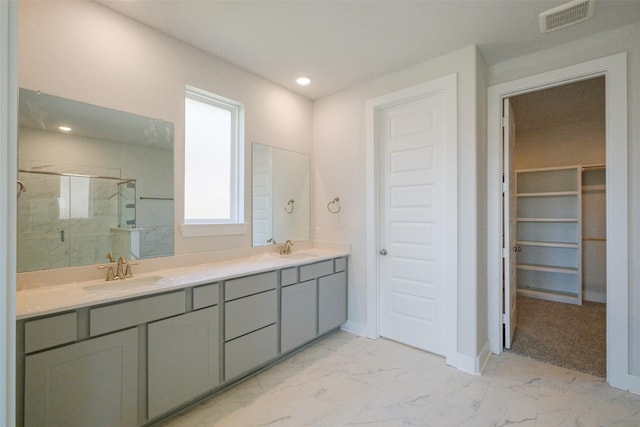 full bathroom with visible vents, marble finish floor, a sink, and a stall shower