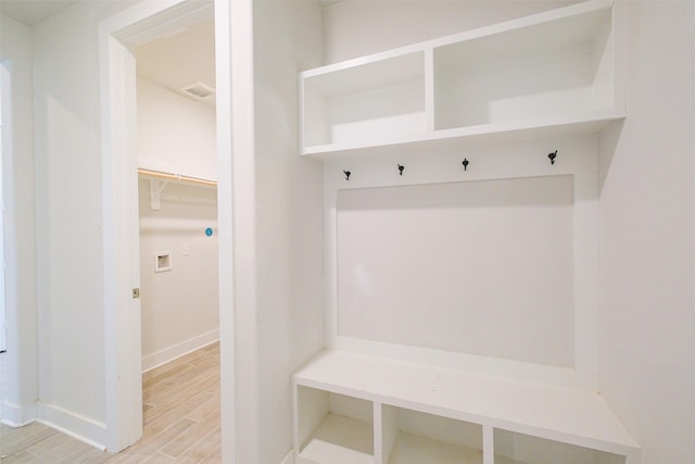mudroom with visible vents, baseboards, and wood finish floors