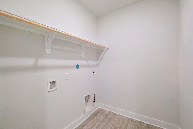 clothes washing area featuring hookup for an electric dryer, gas dryer hookup, washer hookup, laundry area, and wood tiled floor