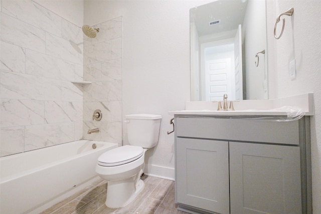 full bathroom with washtub / shower combination, vanity, baseboards, wood finish floors, and toilet
