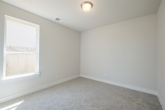 empty room with visible vents, baseboards, and carpet floors