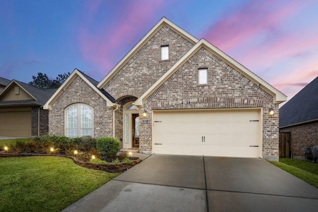 155 Forest Heights Ln, Montgomery, TX 77316 - view of front of property featuring an attached garage, a lawn, brick siding, and driveway