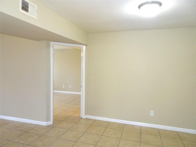 unfurnished room featuring visible vents, baseboards, and light tile patterned flooring
