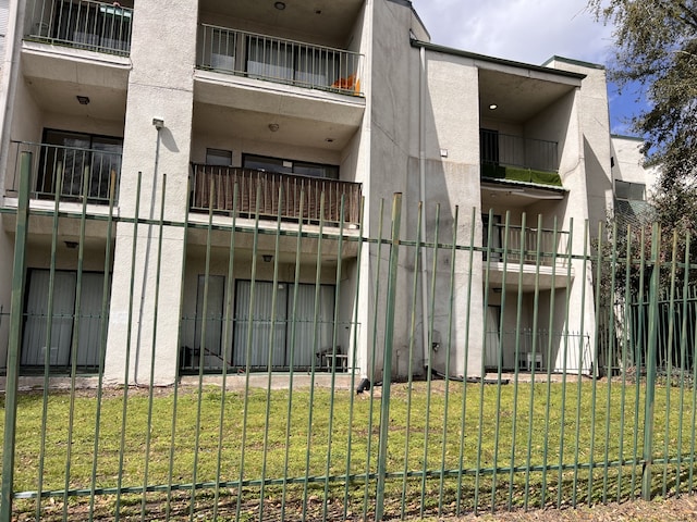 view of building exterior with fence