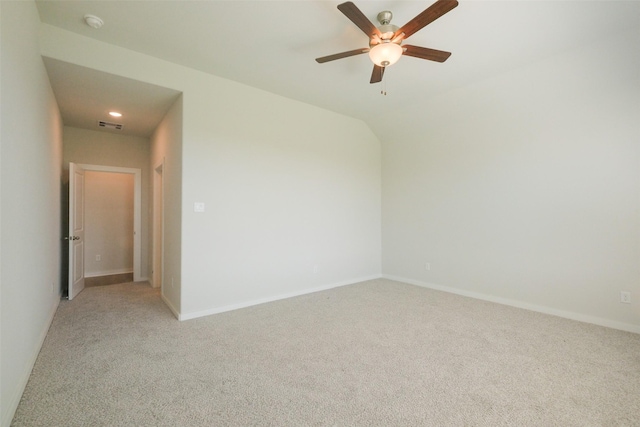 spare room featuring visible vents, baseboards, a ceiling fan, and light carpet