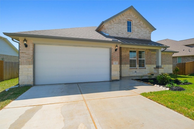 traditional home with brick siding, driveway, stone siding, and fence