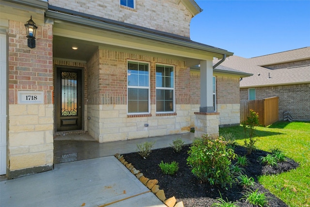 doorway to property featuring brick siding and stone siding