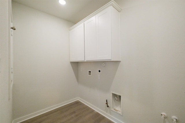 clothes washing area featuring electric dryer hookup, hookup for a gas dryer, baseboards, and dark wood finished floors