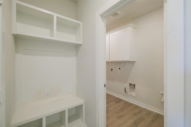 mudroom featuring baseboards, dark wood finished floors, and visible vents