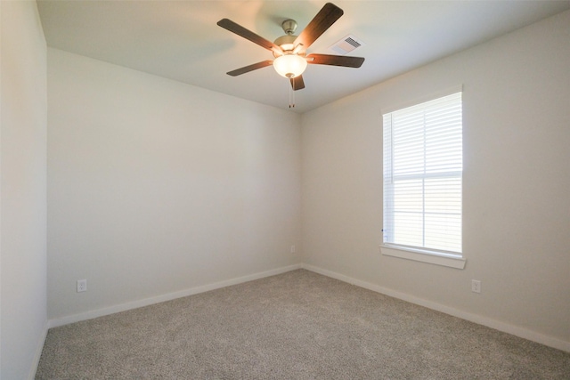 spare room featuring visible vents, baseboards, a ceiling fan, and carpet flooring
