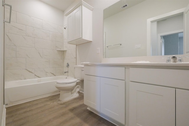full bath featuring toilet, wood finished floors, vanity, and shower / bathtub combination