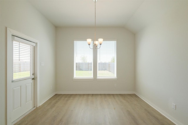 unfurnished dining area featuring a chandelier, light wood finished floors, and baseboards