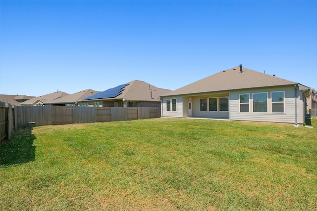 back of property with a yard and a fenced backyard