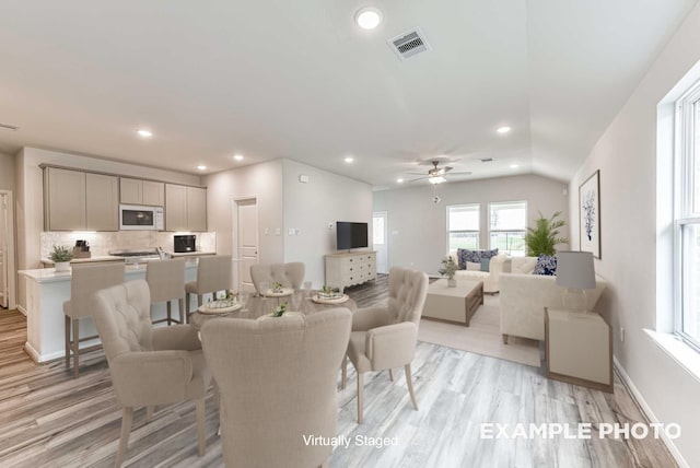 dining space with light wood finished floors, visible vents, baseboards, recessed lighting, and a ceiling fan