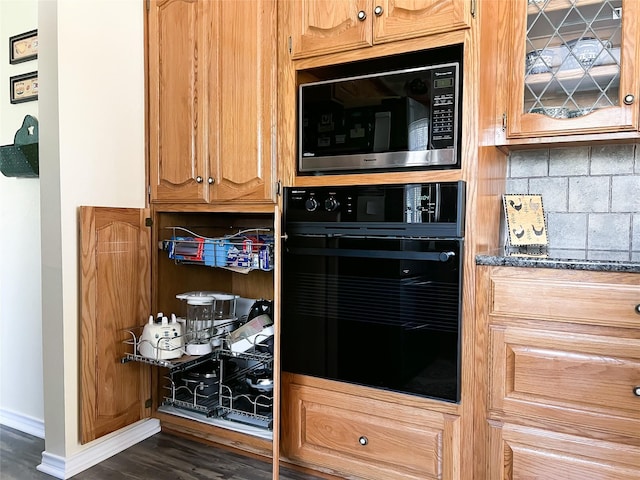 518 Lcr 902, Jewett, TX 75846 - kitchen with oven, tasteful backsplash, dark wood-style flooring, baseboards, and glass insert cabinets