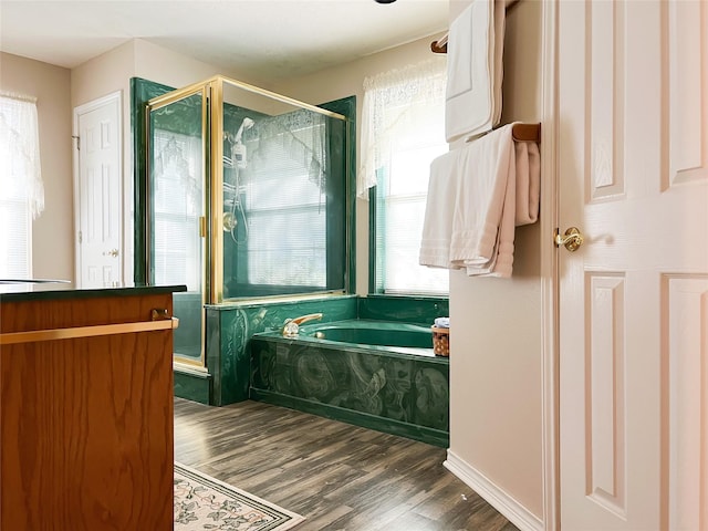 518 Lcr 902, Jewett, TX 75846 - bathroom featuring a bath, wood finished floors, a wealth of natural light, and a stall shower