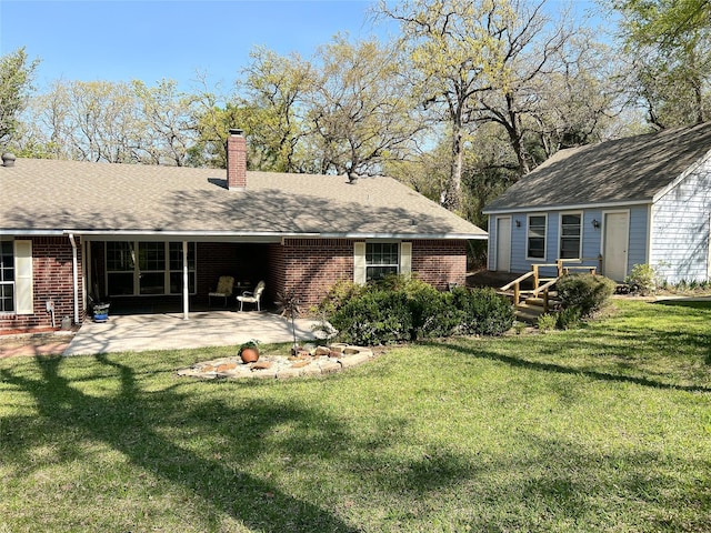 518 Lcr 902, Jewett, TX 75846 - rear view of property with a chimney, brick siding, a patio area, and a lawn