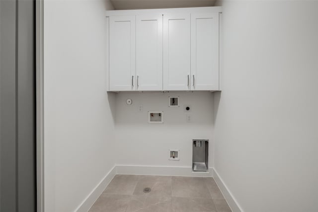 1609 Park St, Houston, TX 77019 - washroom featuring hookup for a gas dryer, electric dryer hookup, cabinet space, hookup for a washing machine, and light tile patterned floors