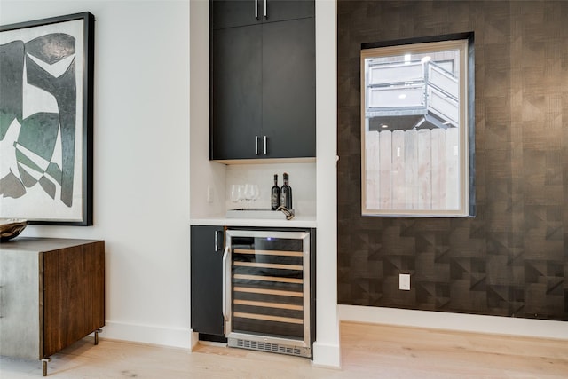 1609 Park St, Houston, TX 77019 - indoor dry bar with wine cooler, baseboards, and light wood-style flooring