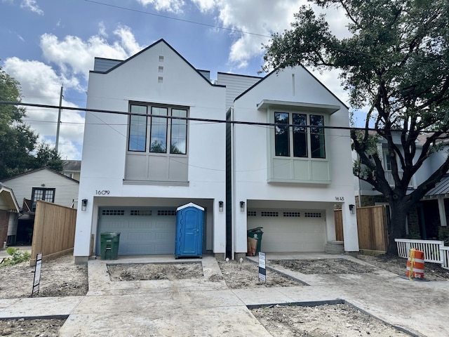 1609 Park St, Houston, TX 77019 - view of front of home featuring stucco siding, a garage, and driveway
