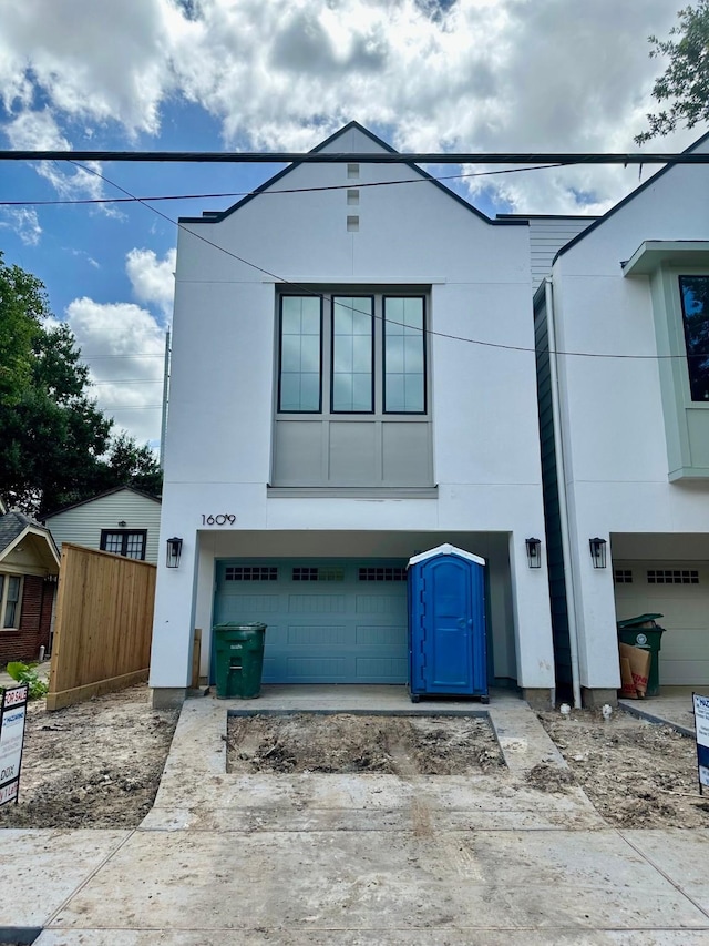 1609 Park St, Houston, TX 77019 - view of front of house with stucco siding and a garage