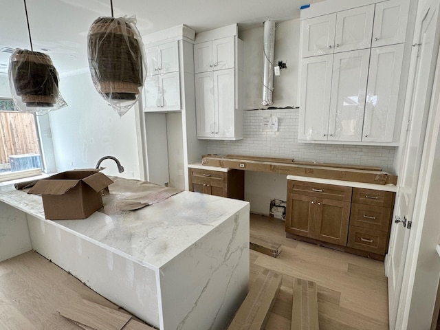1609 Park St, Houston, TX 77019 - kitchen featuring light wood-style floors, decorative backsplash, extractor fan, and hanging light fixtures