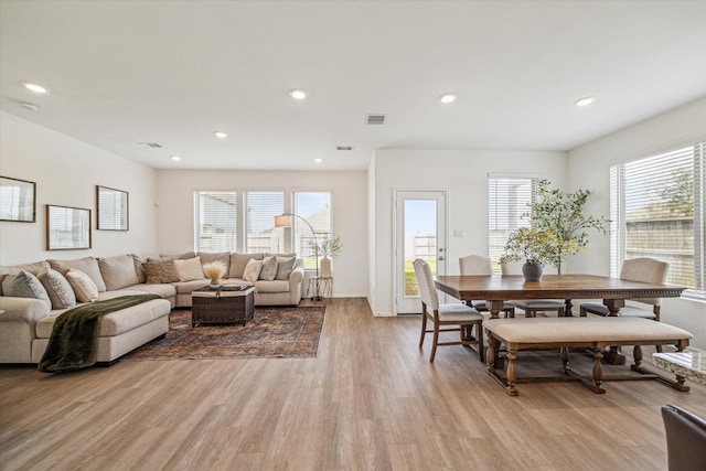 living room with visible vents, recessed lighting, light wood-style flooring, and a wealth of natural light
