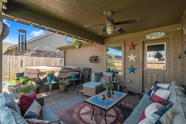 view of patio featuring a ceiling fan, an outdoor living space, and fence