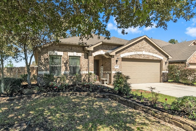 view of front of home with brick siding, fence, concrete driveway, roof with shingles, and a garage