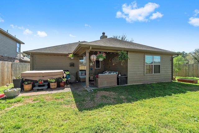 back of house with a patio, a yard, a fenced backyard, and a hot tub