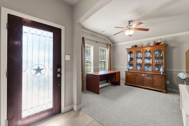 entryway featuring light carpet, ceiling fan, crown molding, and vaulted ceiling