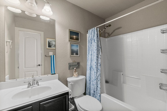 bathroom featuring toilet, shower / tub combo with curtain, vanity, and a textured wall