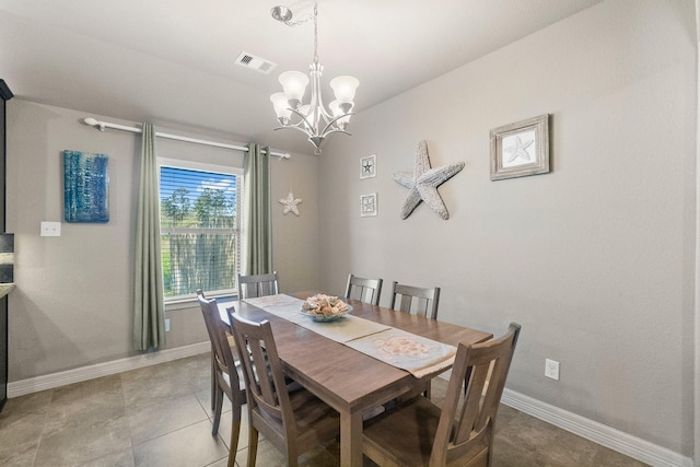 dining room with baseboards, visible vents, and a chandelier