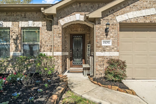 property entrance with stone siding and a garage