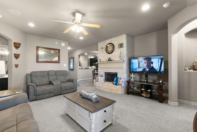 living room featuring baseboards, carpet, recessed lighting, arched walkways, and a ceiling fan