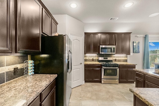 kitchen with visible vents, tasteful backsplash, recessed lighting, dark brown cabinetry, and appliances with stainless steel finishes