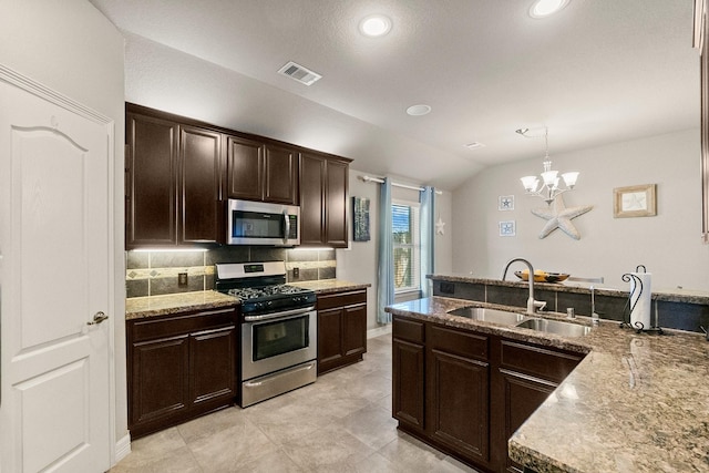 kitchen with visible vents, a sink, tasteful backsplash, appliances with stainless steel finishes, and dark brown cabinets