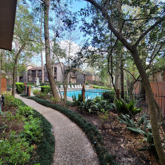 exterior space featuring a community pool and fence