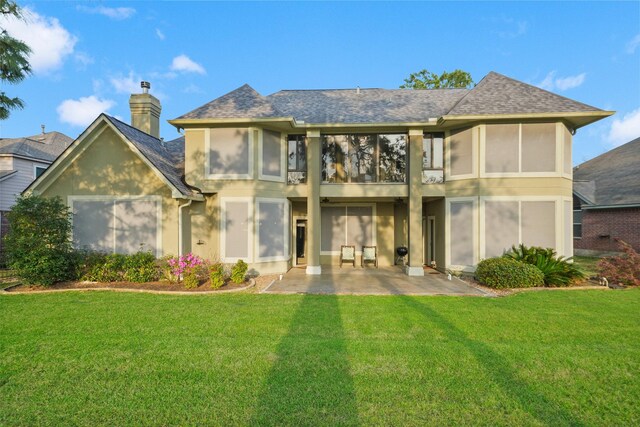 18719 Rusty Anchor Ct, Humble, TX 77346 - back of house with stucco siding, a patio, a yard, a shingled roof, and a chimney