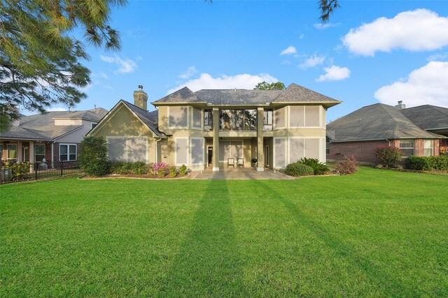 18719 Rusty Anchor Ct, Humble, TX 77346 - rear view of house featuring a patio area, stucco siding, a chimney, and a yard