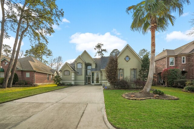 18719 Rusty Anchor Ct, Humble, TX 77346 - view of front facade featuring stucco siding, concrete driveway, and a front lawn