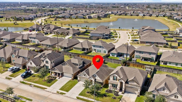 birds eye view of property with a residential view and a water view