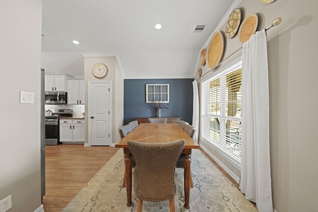 dining room with visible vents, recessed lighting, light wood-type flooring, and lofted ceiling