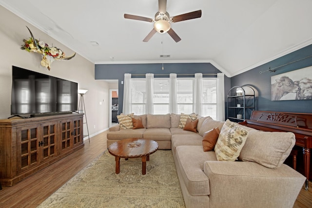 living room featuring visible vents, crown molding, ceiling fan, vaulted ceiling, and wood finished floors