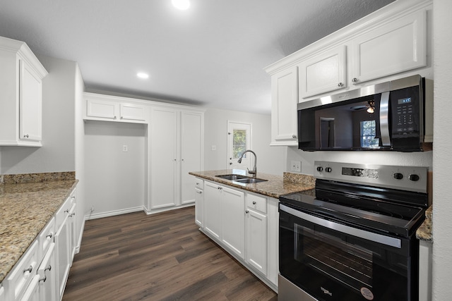 8355 Glencrest St, Houston, TX 77061 - kitchen featuring appliances with stainless steel finishes, dark wood-type flooring, white cabinetry, light stone counters, and recessed lighting